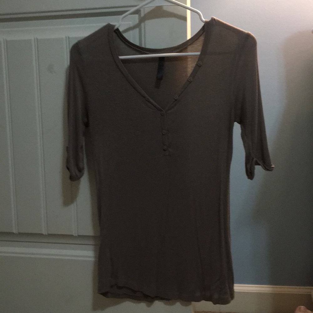 A light brownish, shirt with buttons.